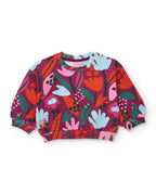 Takımın çiçek desenli crop sweatshirti önden; büzgülü etek ucunda Love Earth etiketi görünüyor.
