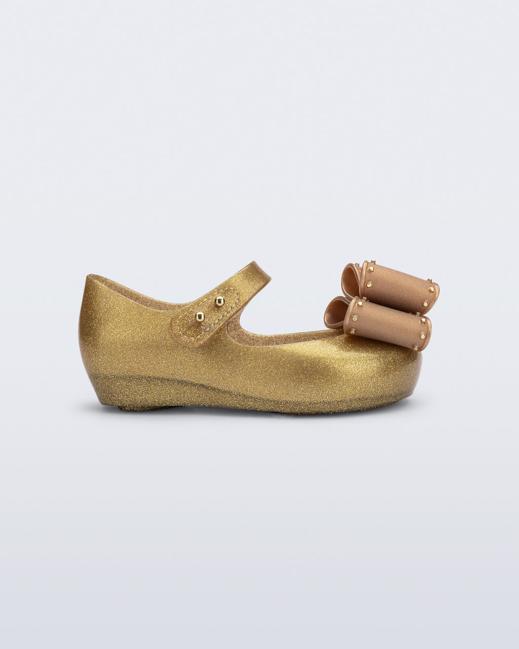 Cırt cırtlı bandı ve esnek Melflex yapısıyla Mini Melissa Ultragirl Classic Bow simli altın babet ayakkabı yan profil