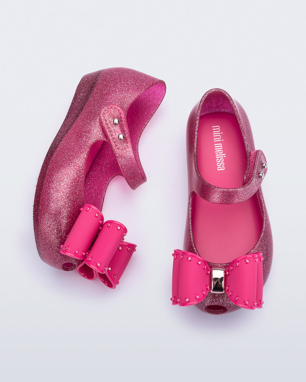İkonik kokulu Mini Melissa pembe fiyonklu çocuk ayakkabısı yumuşak iç taban ve cırt cırt detaylı üstten görünüm