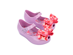 Mini Melissa Ultragirl Wonderland BB lila pembe fiyonklu çocuk ayakkabı – önden çapraz görünüm, parlak lila yüzey, enerjik pembe fiyonk detayı, şık ve eğlenceli tasarım