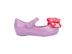 Mini Melissa Ultragirl Wonderland BB lila çocuk ayakkabı – sağ yan görünüm, pembe fiyonk detaylı, esnek ve rahat yapı