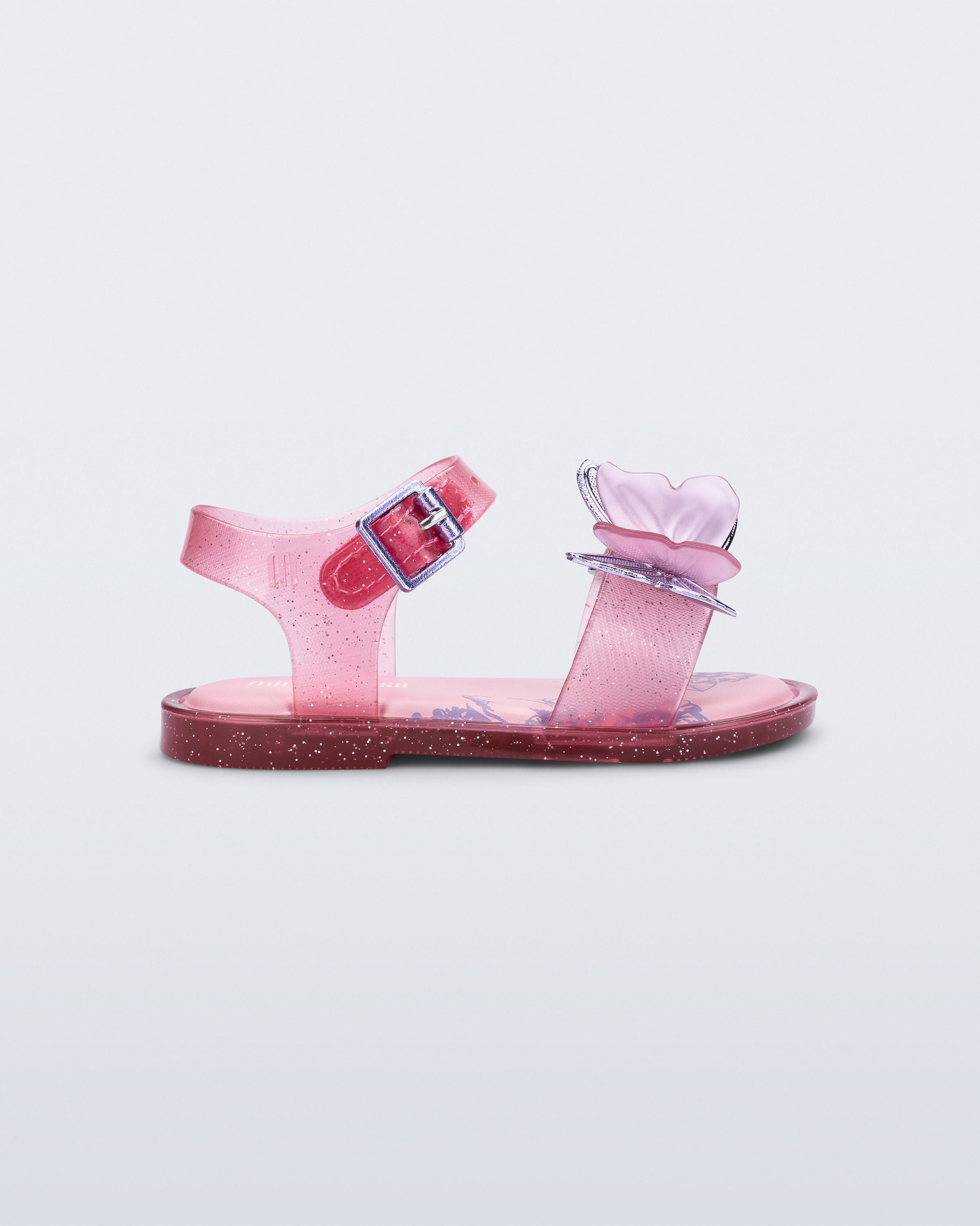 Simli pembe Mini Melissa Fly Sandal III Baby yan görünüm, velcro ve toka kapama sistemi