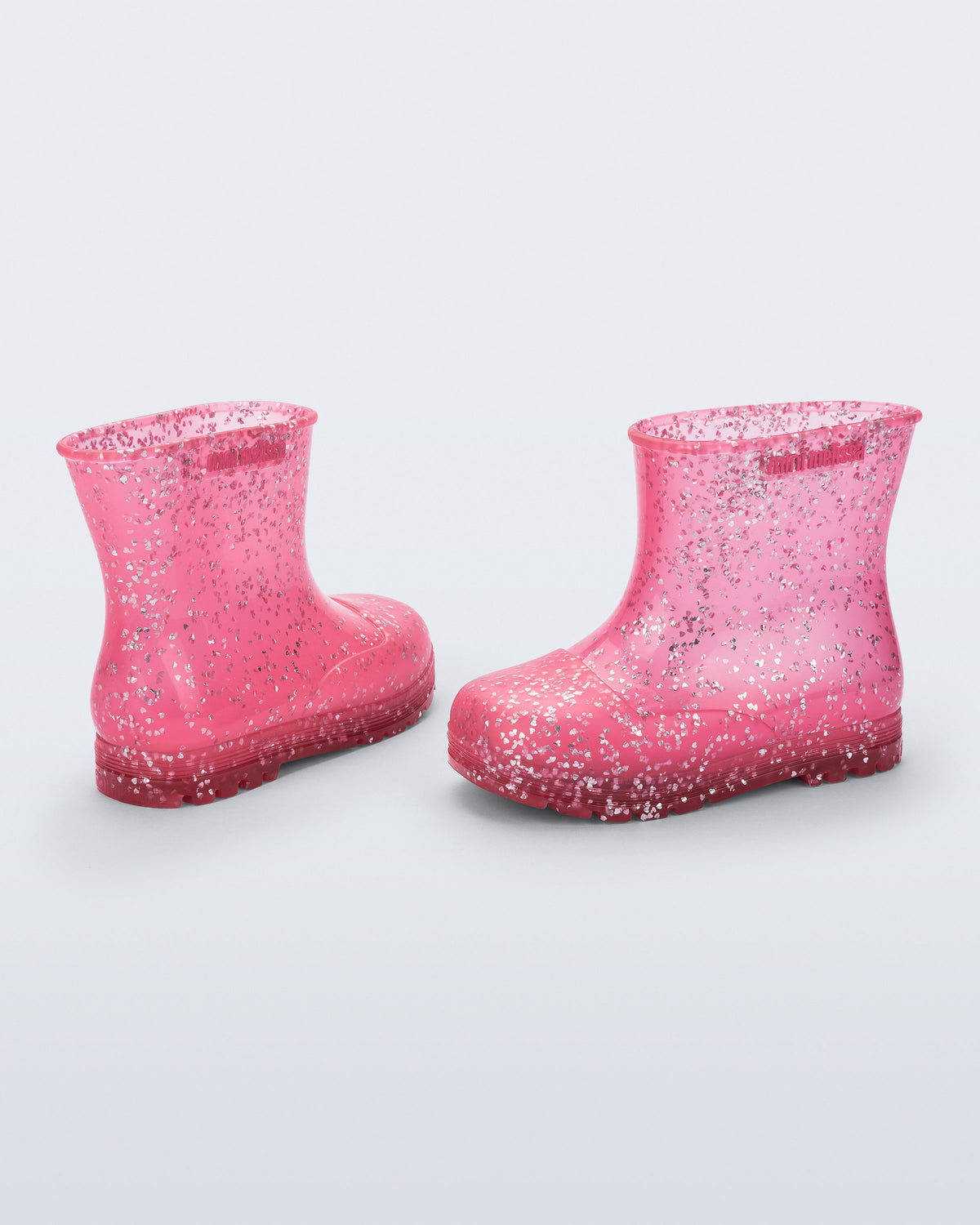 Şeffaf pembe Mini Melissa Welly Shiny çifti üstten açıyla; simli kalp parçacıkları net görünüyor.