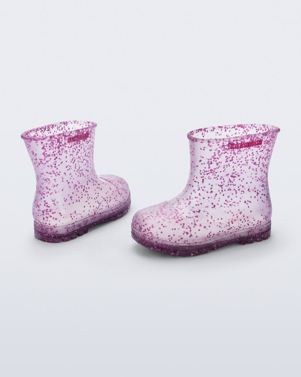 Şeffaf lila Mini Melissa Welly Shiny çifti üstten açıyla; simli kalp parçacıkları net görünüyor.