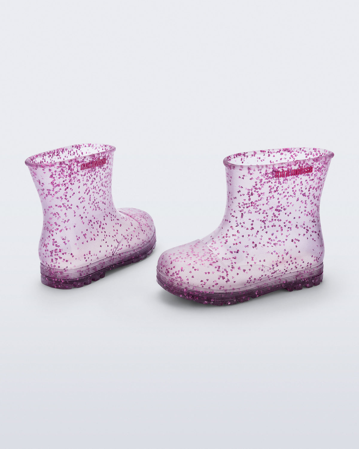 Şeffaf lila Mini Melissa Welly Shiny çifti üstten açıyla; simli kalp parçacıkları net görünüyor.