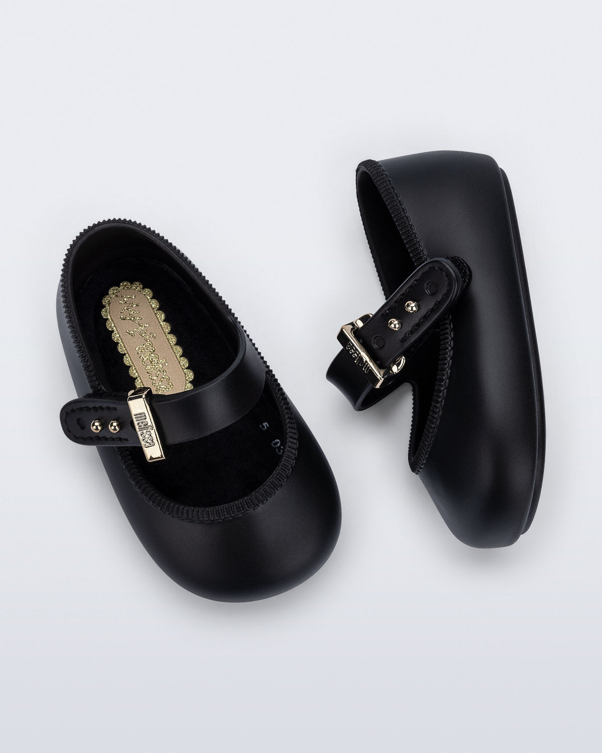 Mini Melissa siyah bebek babeti üstten görünüm, peluş kaplı yumuşak iç taban